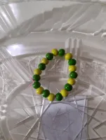 Green and yellow childs bracelet wooden